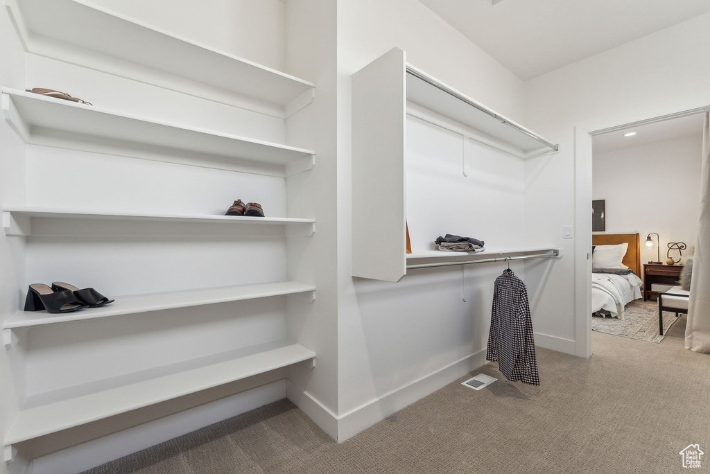 Walk in closet featuring carpet flooring