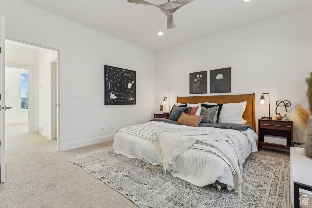 Bedroom with light colored carpet, recessed lighting, and a ceiling fan