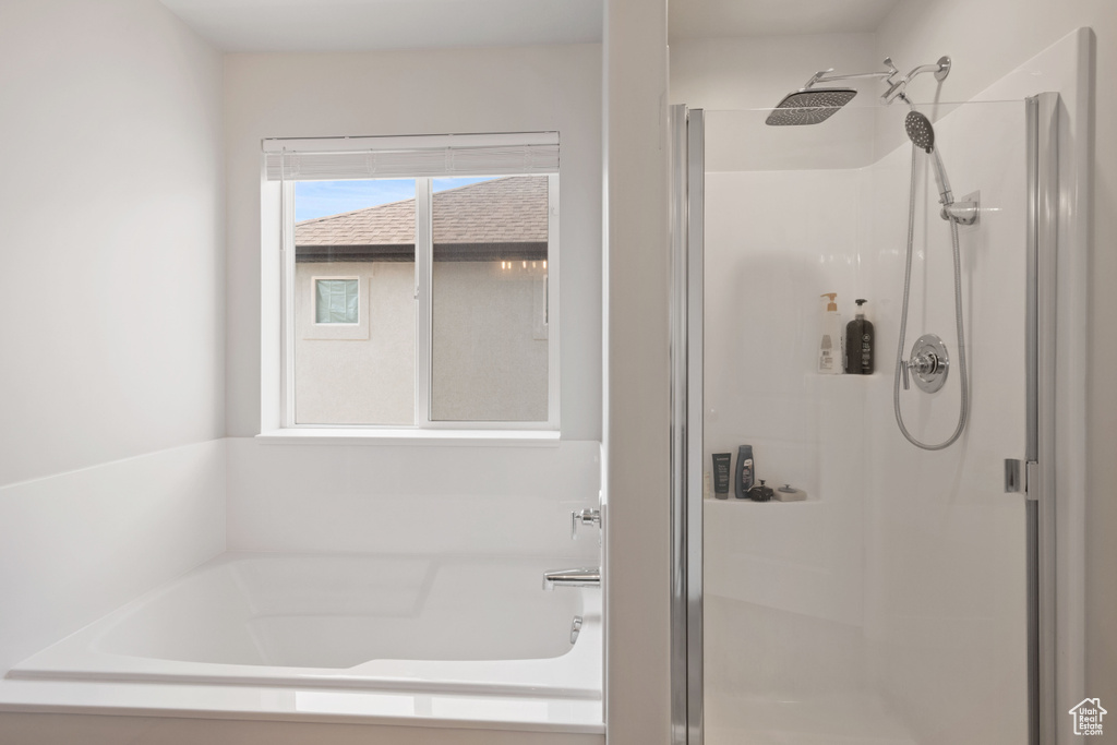 Full bath featuring a stall shower and a garden tub