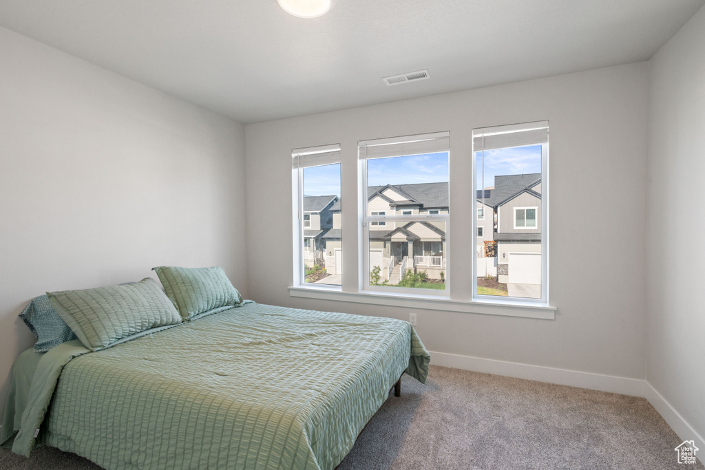 Carpeted bedroom with baseboards