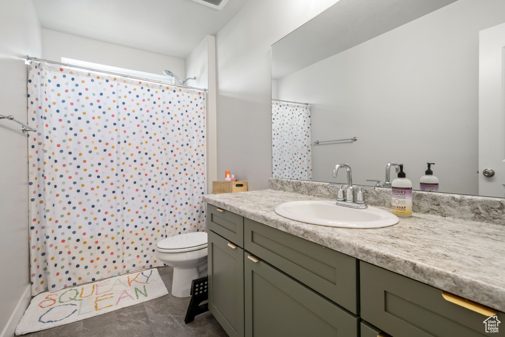 Bathroom featuring vanity and curtained shower
