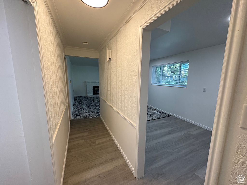 Hall featuring ornamental molding and wood finished floors
