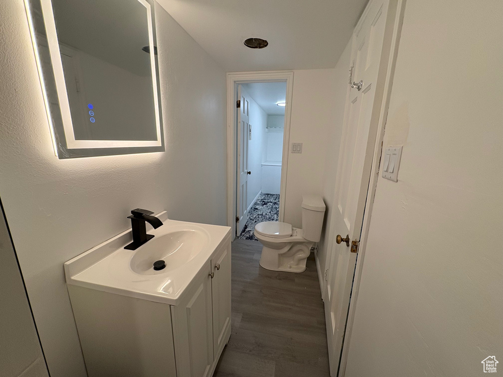 Bathroom with vanity and wood finished floors