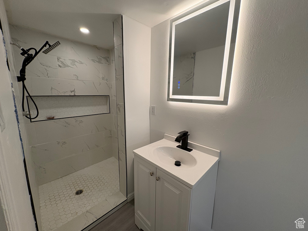 Full bath with vanity, a shower stall, and recessed lighting