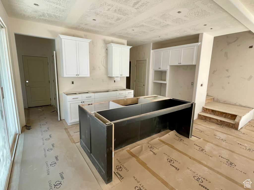 Kitchen featuring a center island and white cabinets
