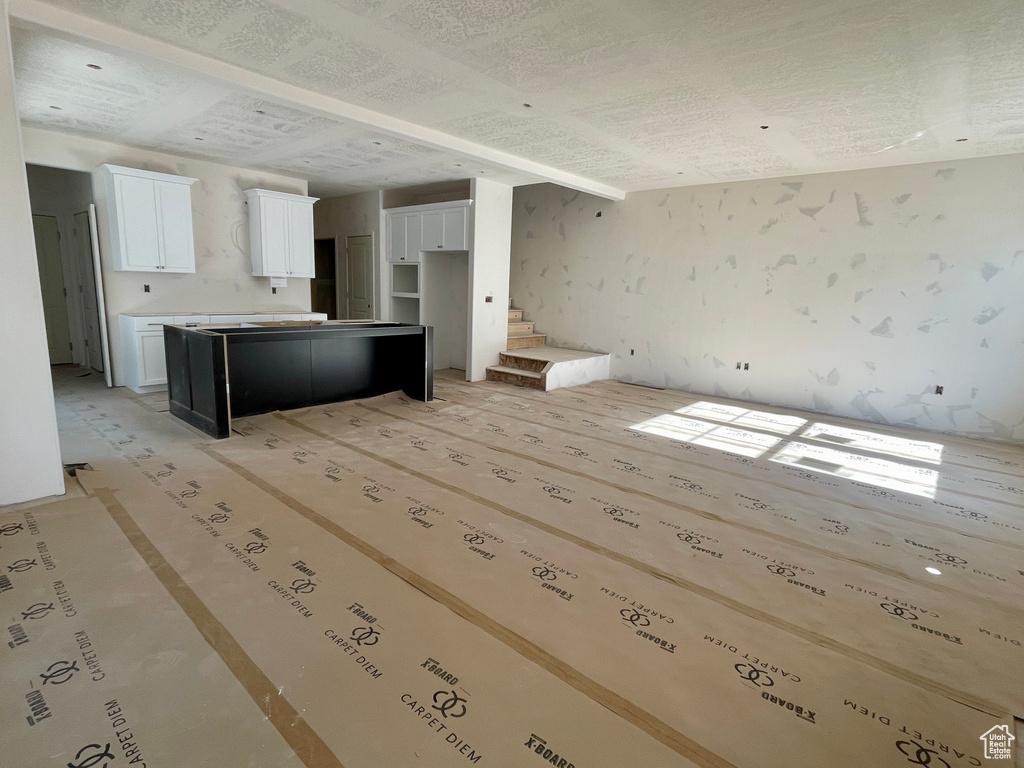 Unfurnished living room with stairway
