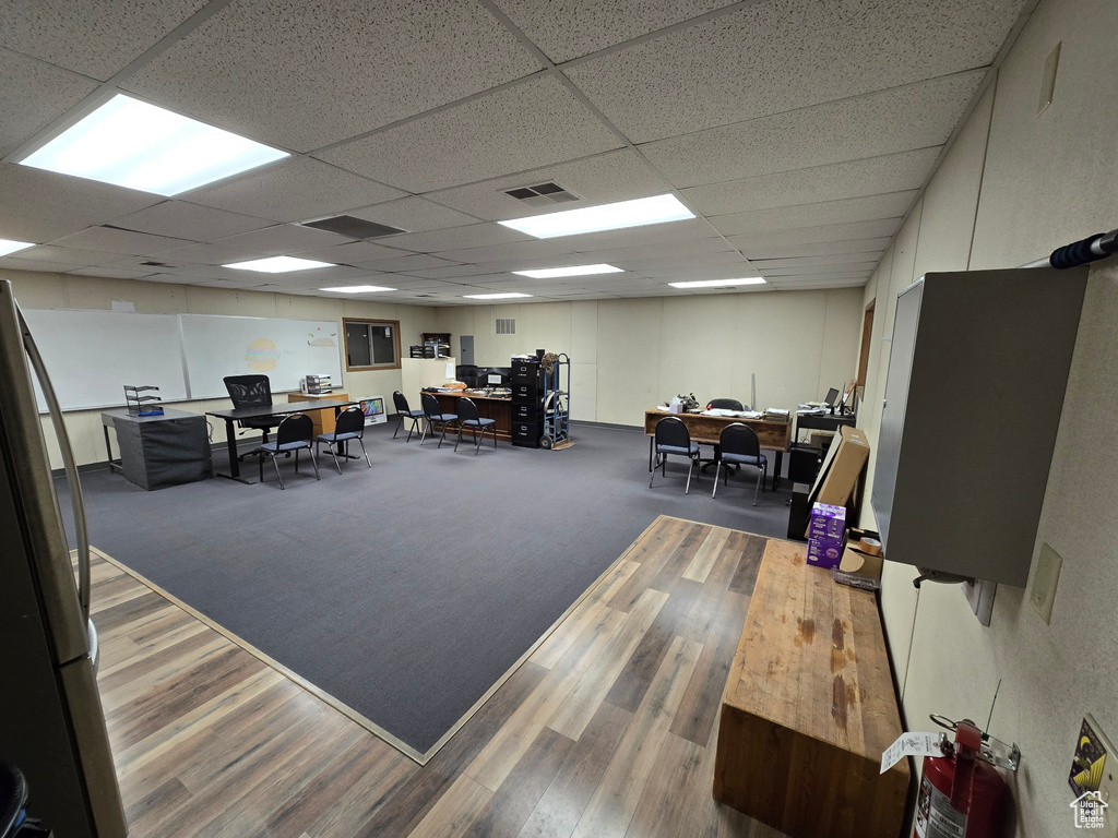 Home office featuring a drop ceiling and wood finished floors