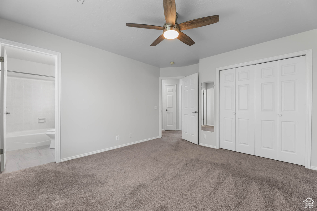 Unfurnished bedroom with carpet floors, ensuite bath, a closet, and ceiling fan