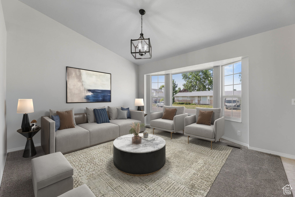 Carpeted living room with a chandelier and vaulted ceiling