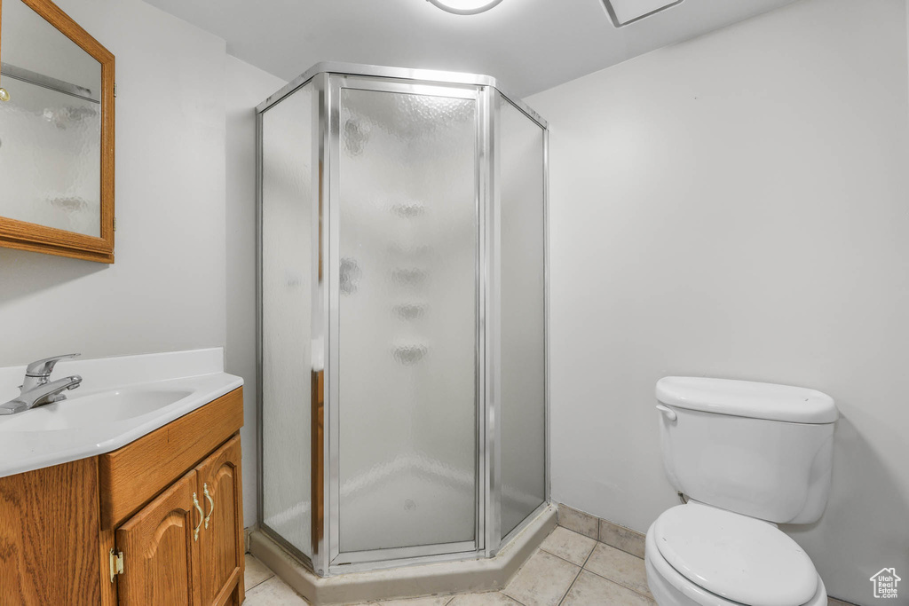 Full bath featuring vanity, a shower stall, and tile patterned floors
