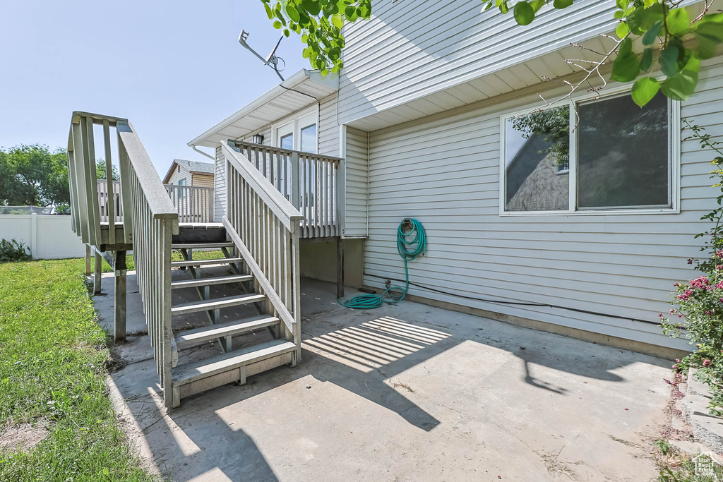 View of patio featuring stairway and a deck