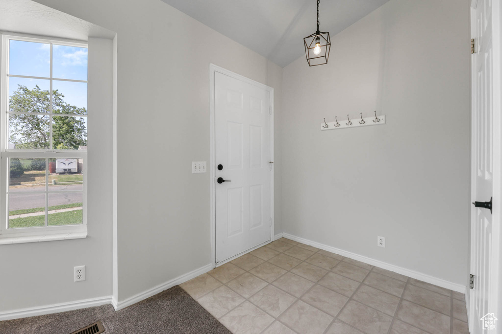 Entrance foyer with baseboards and lofted ceiling