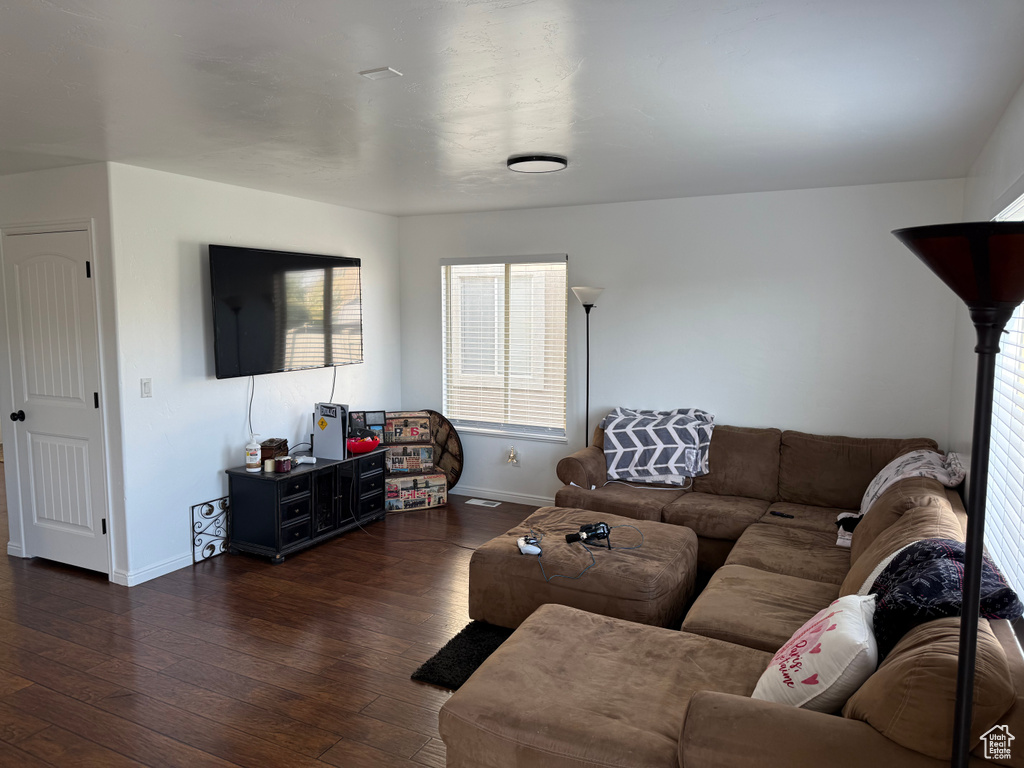 Living room featuring baseboards and wood-type flooring