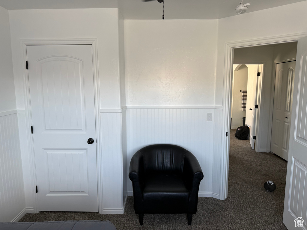 Living area featuring wainscoting and carpet floors