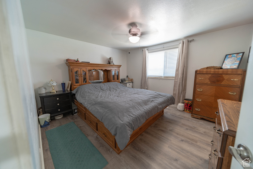 Bedroom featuring wood finished floors and a ceiling fan