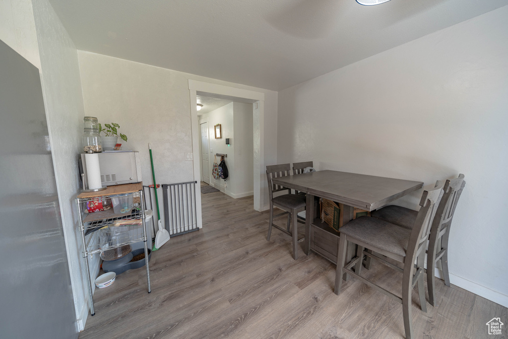 Dining room with wood finished floors and baseboards