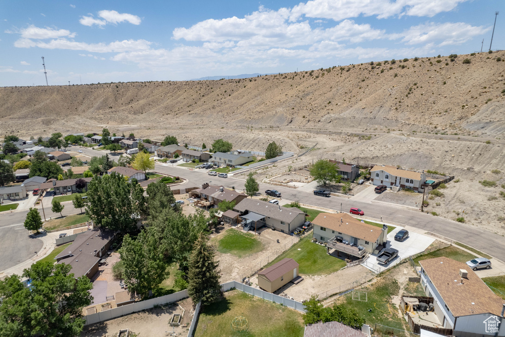 Aerial view of property and surrounding area with nearby suburban area