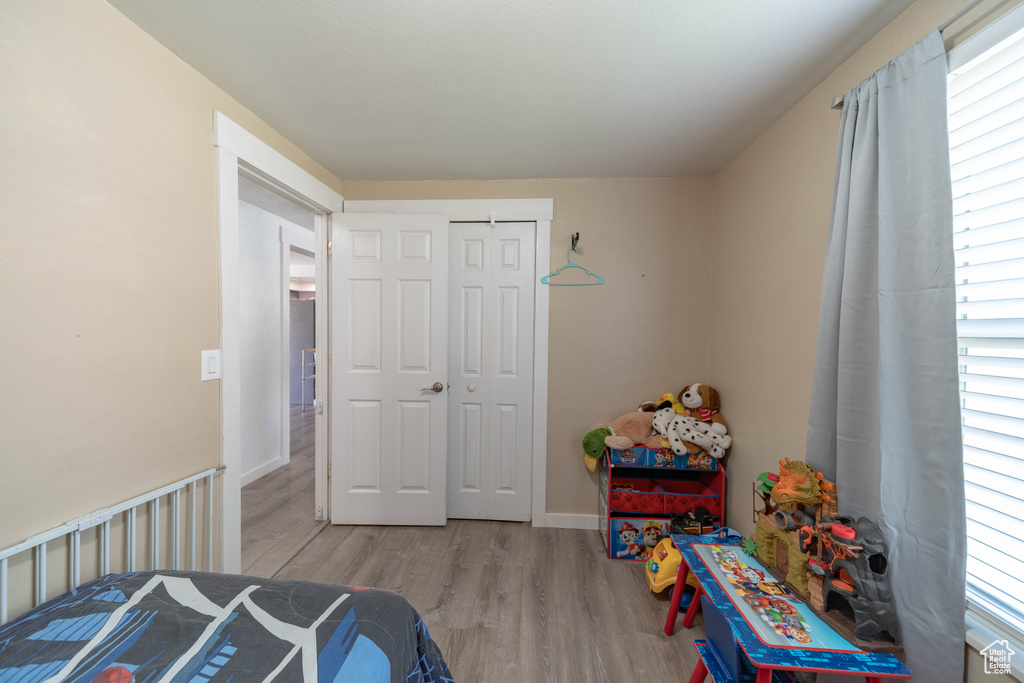 Bedroom featuring wood finished floors and a closet