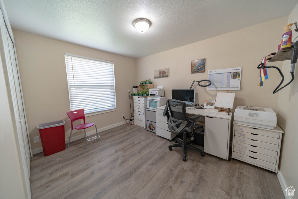 Office area featuring wood finished floors and baseboards