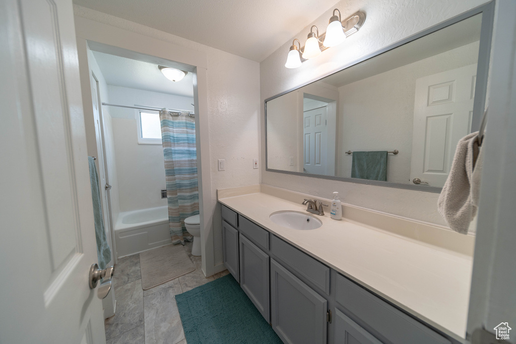 Bathroom featuring vanity and shower / bath combo with shower curtain