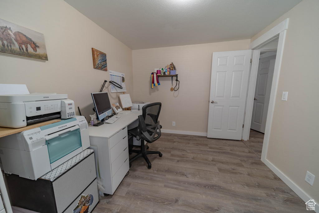 Office with wood finished floors and baseboards