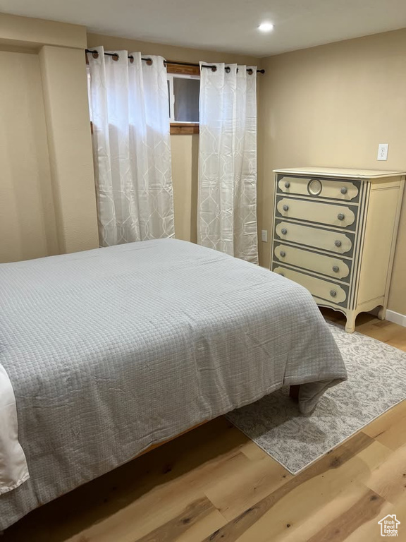 Bedroom with wood finished floors and recessed lighting