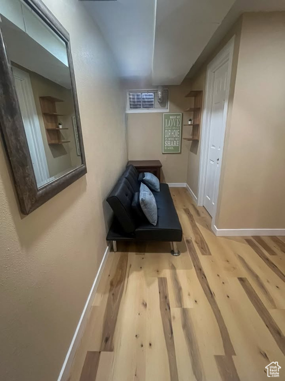 Hallway with wood finished floors and baseboards