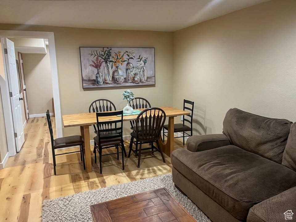 Dining space with wood finished floors and baseboards