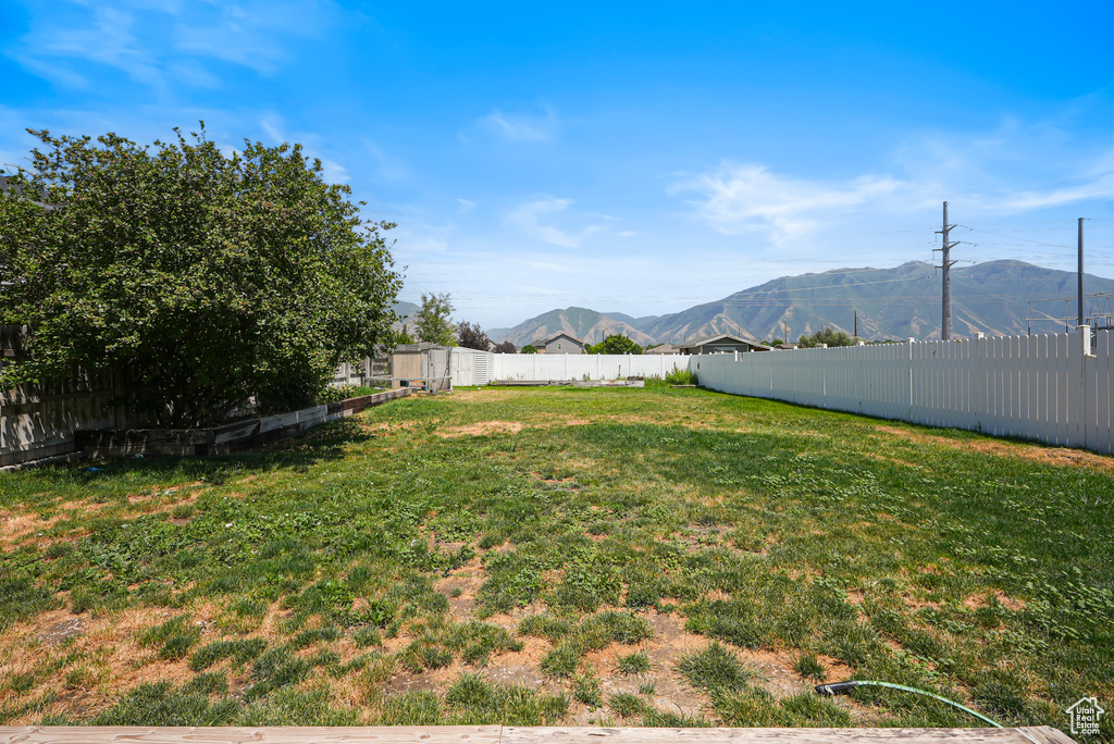 Fenced backyard featuring a mountain view