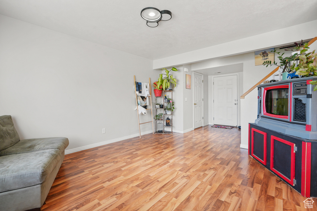 Sitting room featuring light wood-style floors and baseboards
