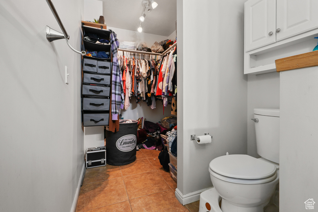Bathroom featuring tile patterned flooring and a spacious closet