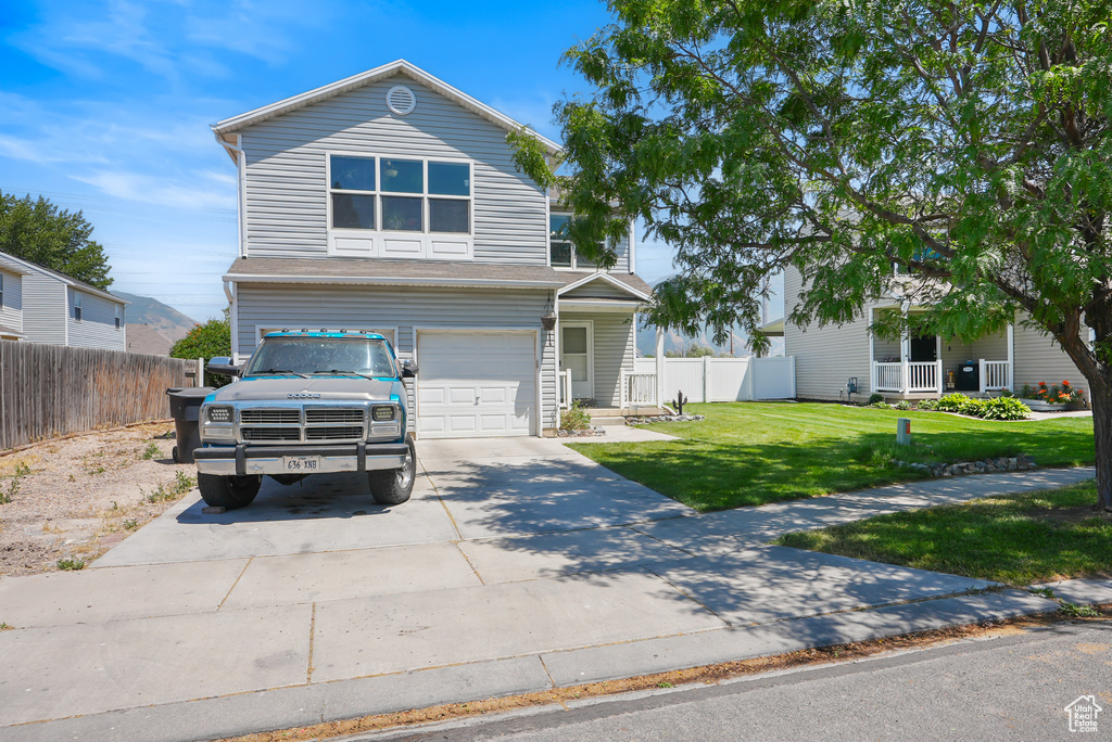 Traditional-style house with concrete driveway and a garage