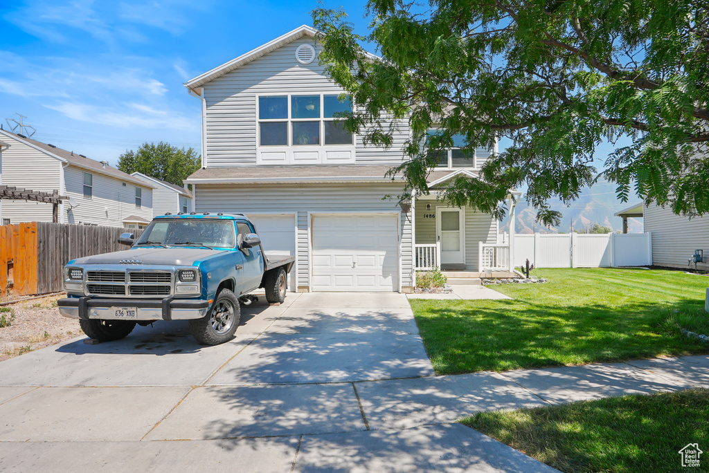 View of front of home with driveway and an attached garage