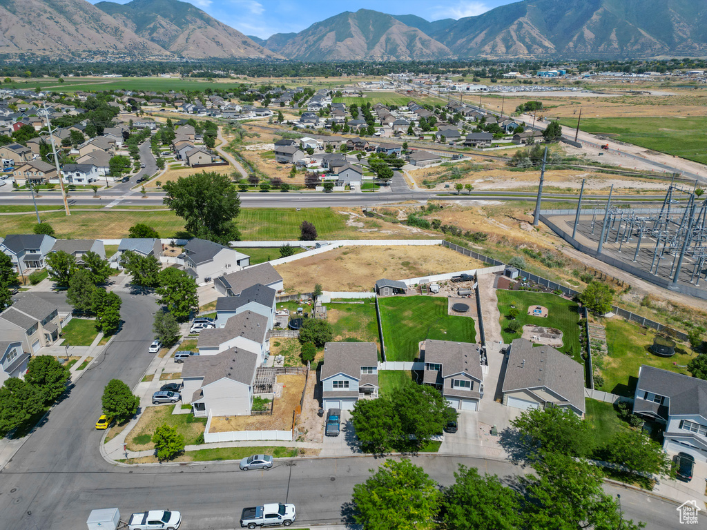 Aerial view of property's location featuring nearby suburban area and mountains