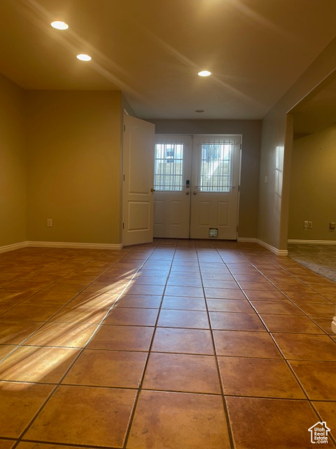 Entryway with french doors, tile patterned flooring, and recessed lighting