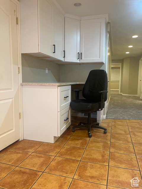 Office space with built in study area, recessed lighting, and light tile patterned floors