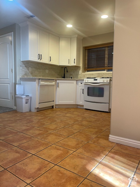 Kitchen featuring white appliances, backsplash, white cabinetry, light tile patterned floors, and recessed lighting