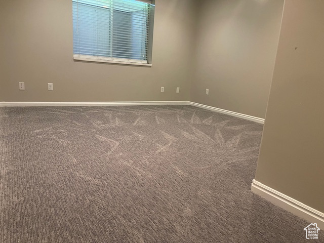 Unfurnished room with carpet and baseboards