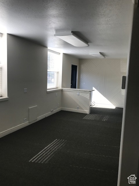 Empty room featuring a textured ceiling