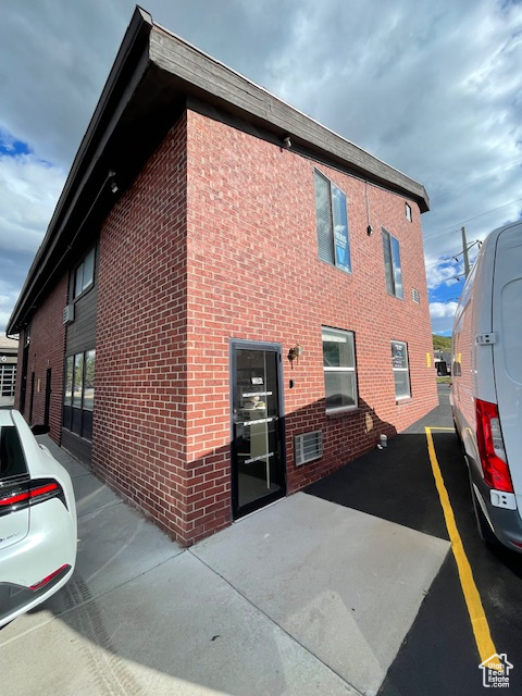 Rear view of house with brick siding