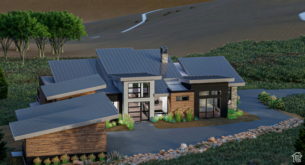 Back of property featuring a chimney, stone siding, a standing seam roof, and a metal roof