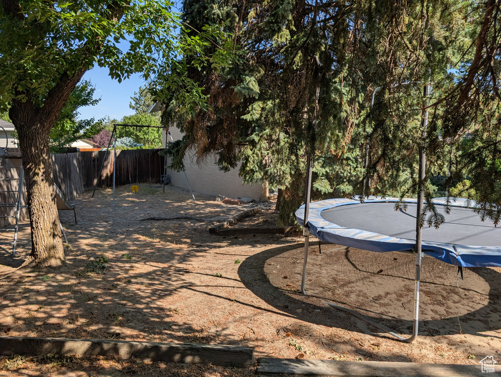 View of yard featuring a trampoline