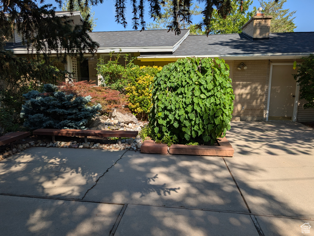 View of front facade with a chimney and a patio
