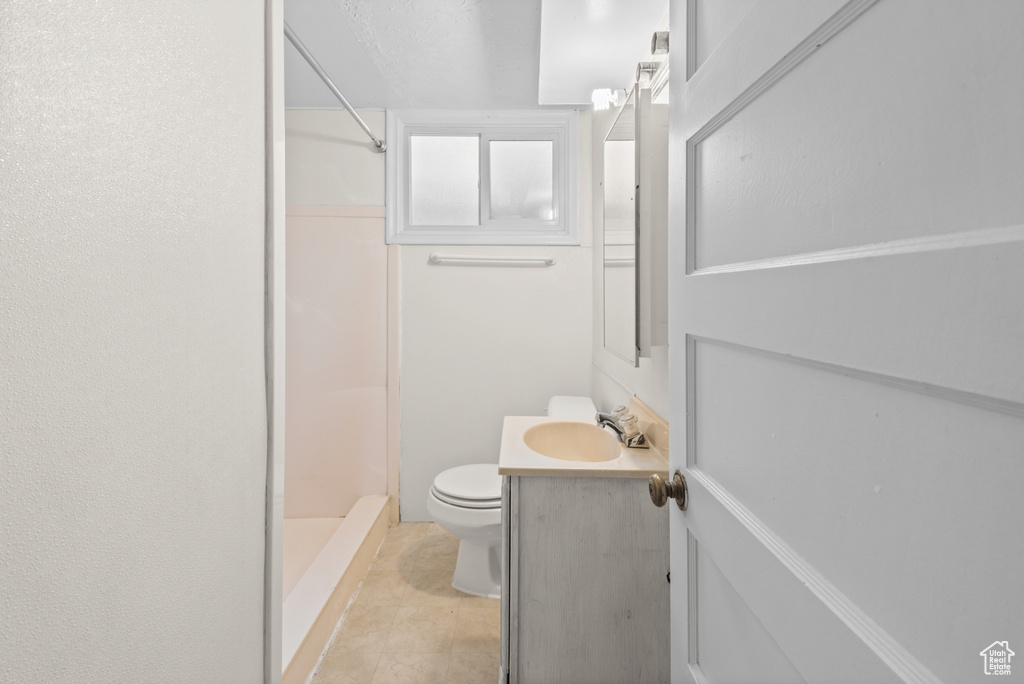 Bathroom featuring vanity, a stall shower, and tile patterned flooring