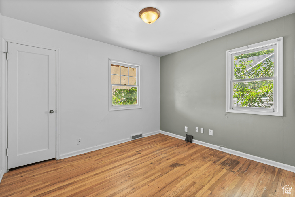 Empty room with light wood-style floors and baseboards