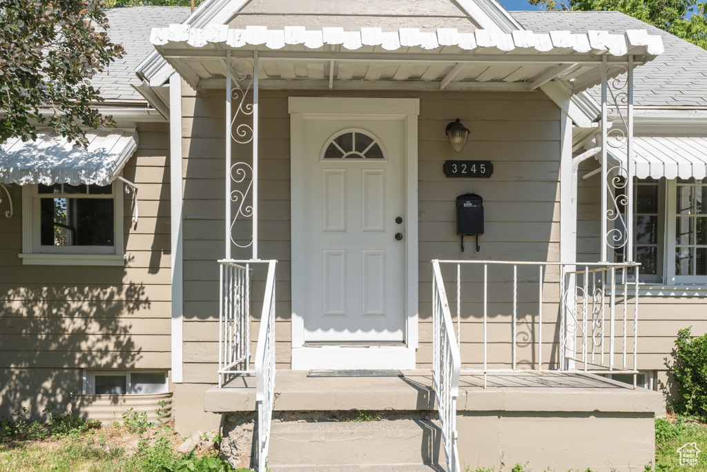 Property entrance with a shingled roof