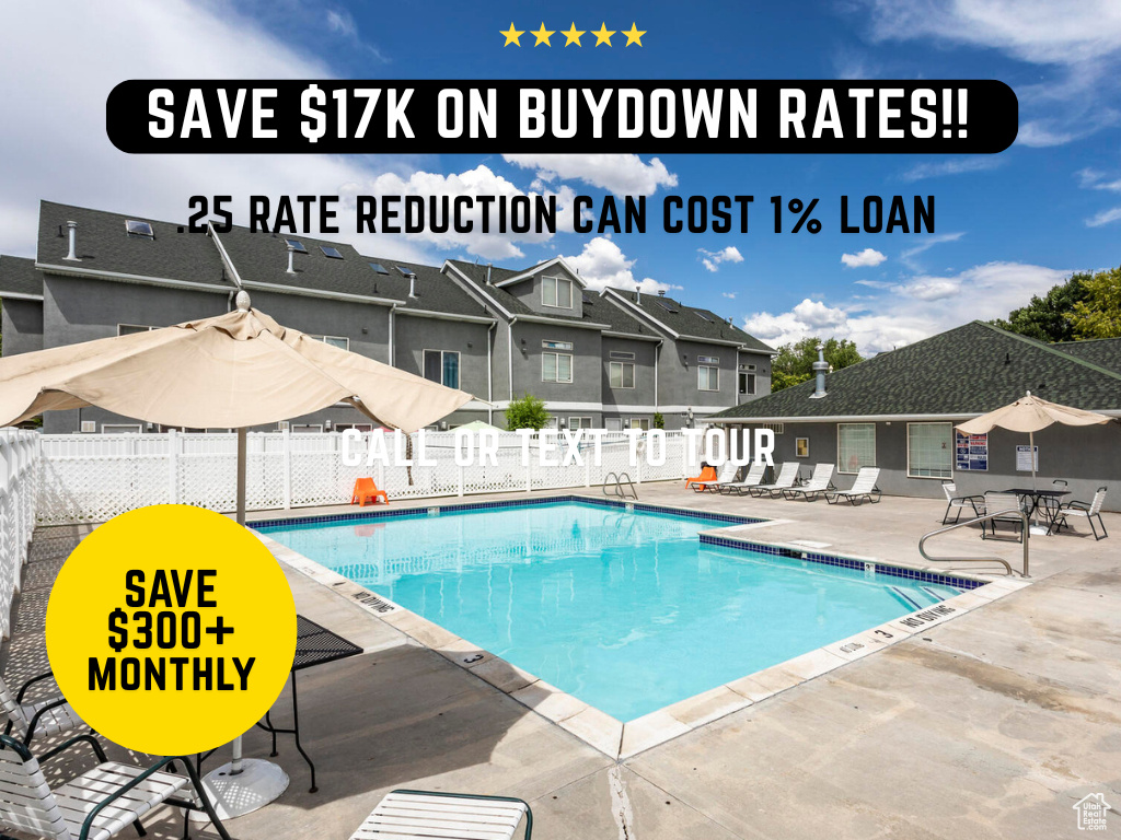 Community pool with a patio area and a residential view
