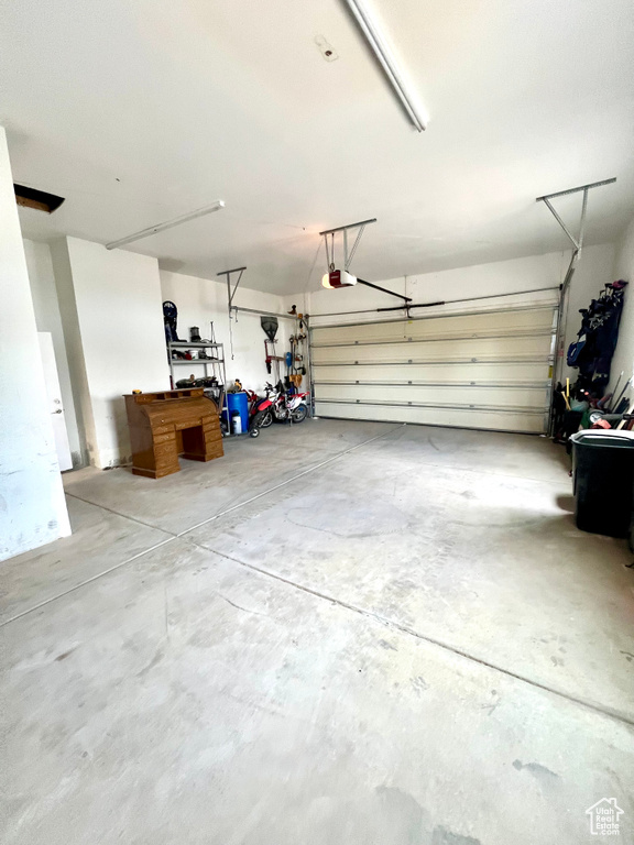 Garage featuring a garage door opener