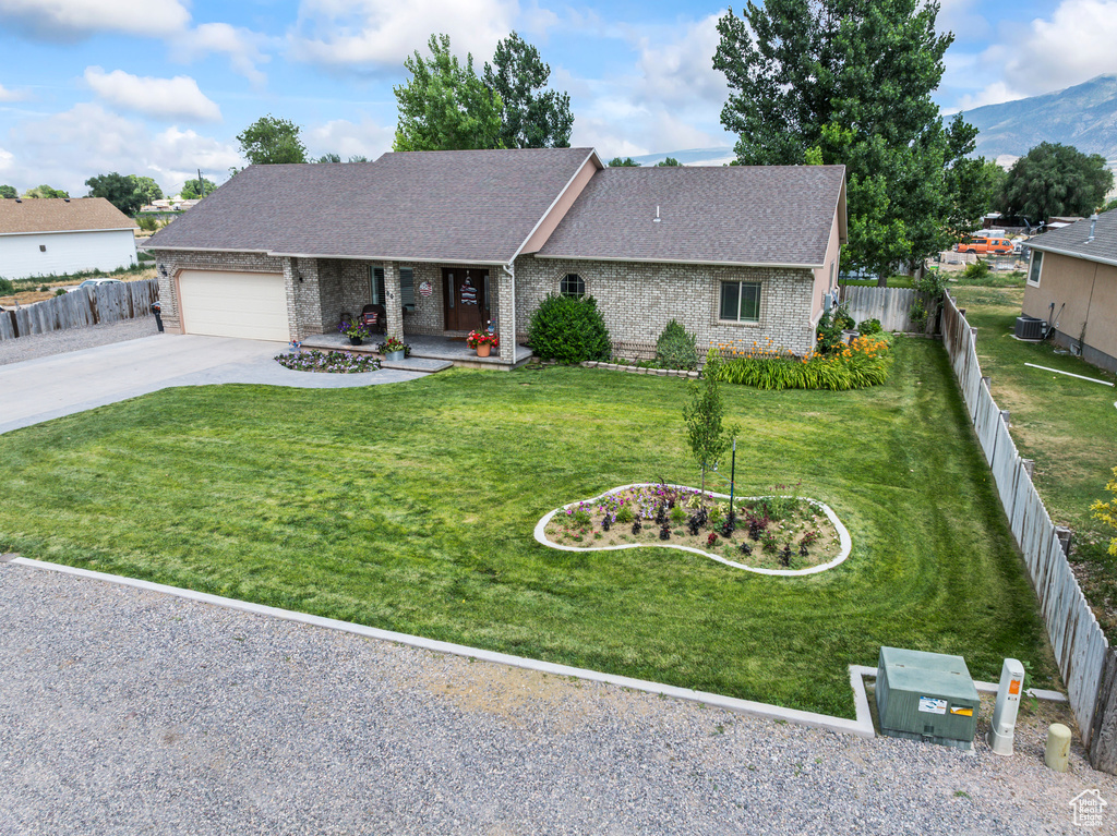 View of front of property featuring concrete driveway, brick siding, an attached garage, roof with shingles, and a porch
