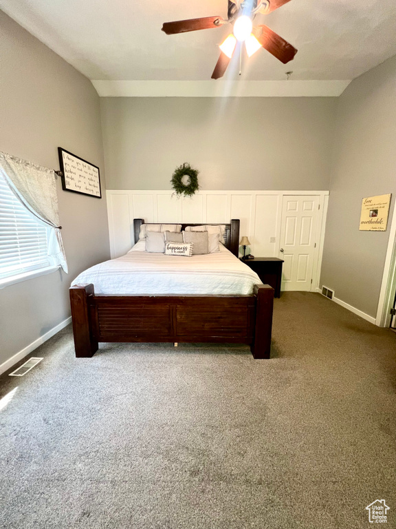 Bedroom featuring dark carpet and a ceiling fan